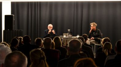 Dwie osoby rozmawiają na scenie przed publicznością