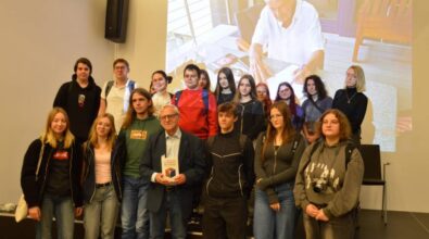 Autor książki pozuje do zdjęcia z grupa uczniów, którzy przyszli na spotkanie.